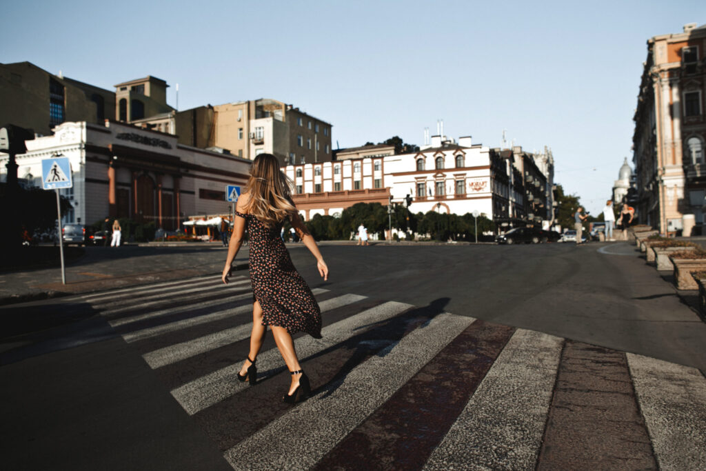 Pedestrian crossing an urban intersection, illustrating privacy-preserving intersection risk detection