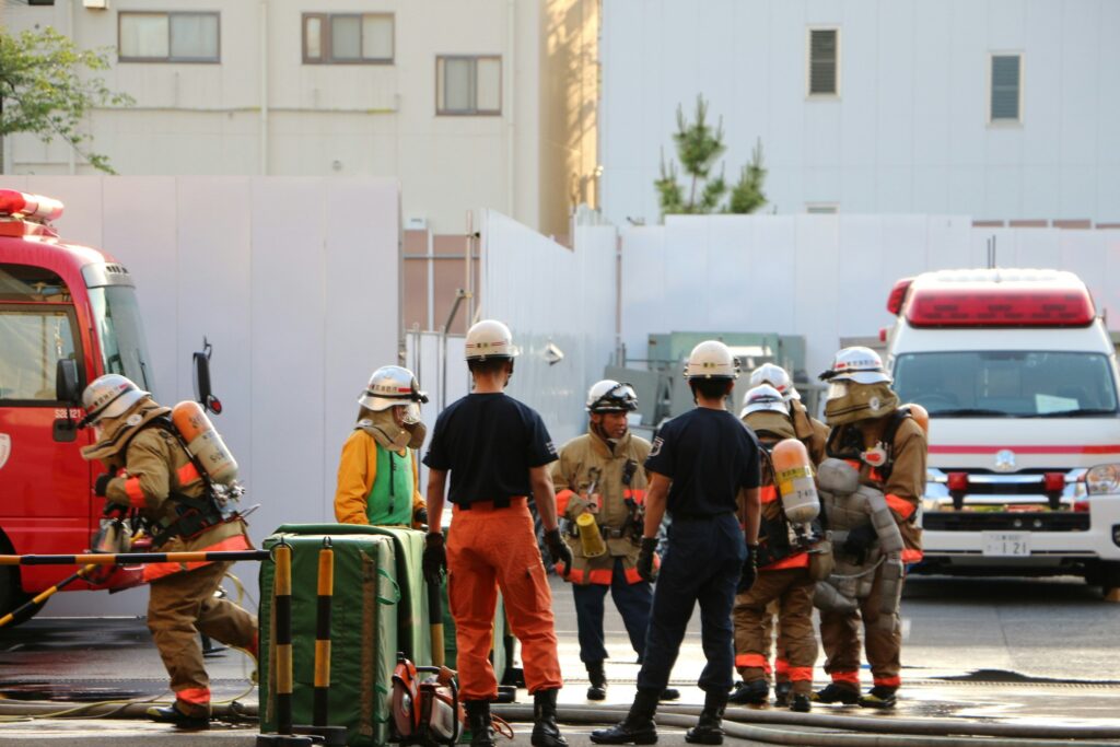 Firefighters and emergency personnel with a fire truck and an ambulance