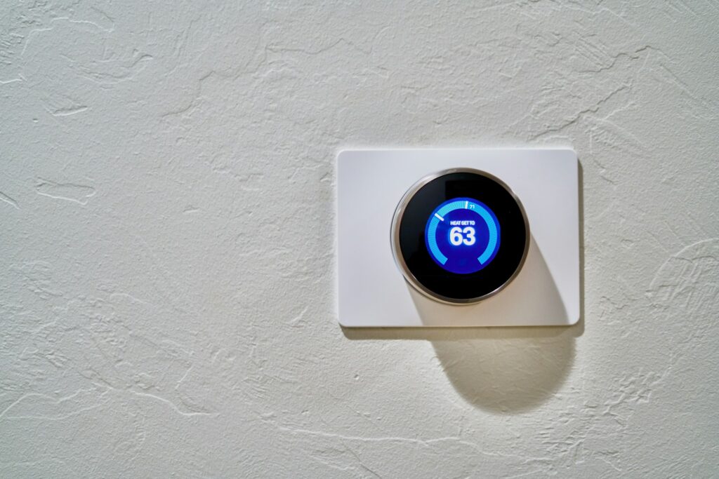 White digital thermostat on a wall