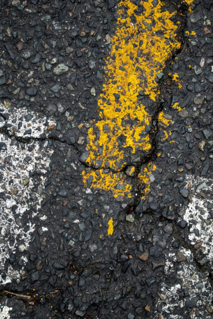 Cracked asphalt with faded road markings