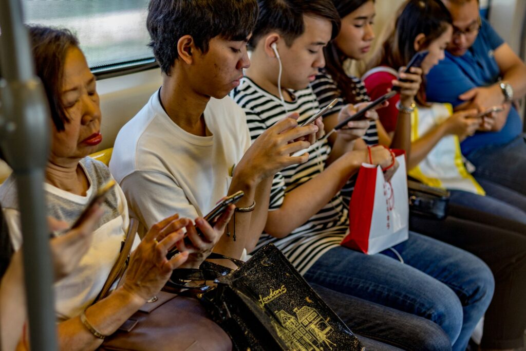 Commuters using smartphones on public transport