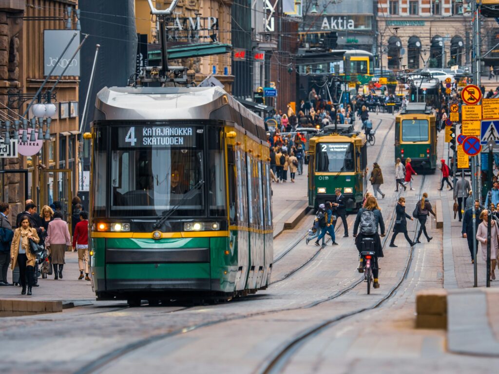 Green and yellow city tram on a street in Finland